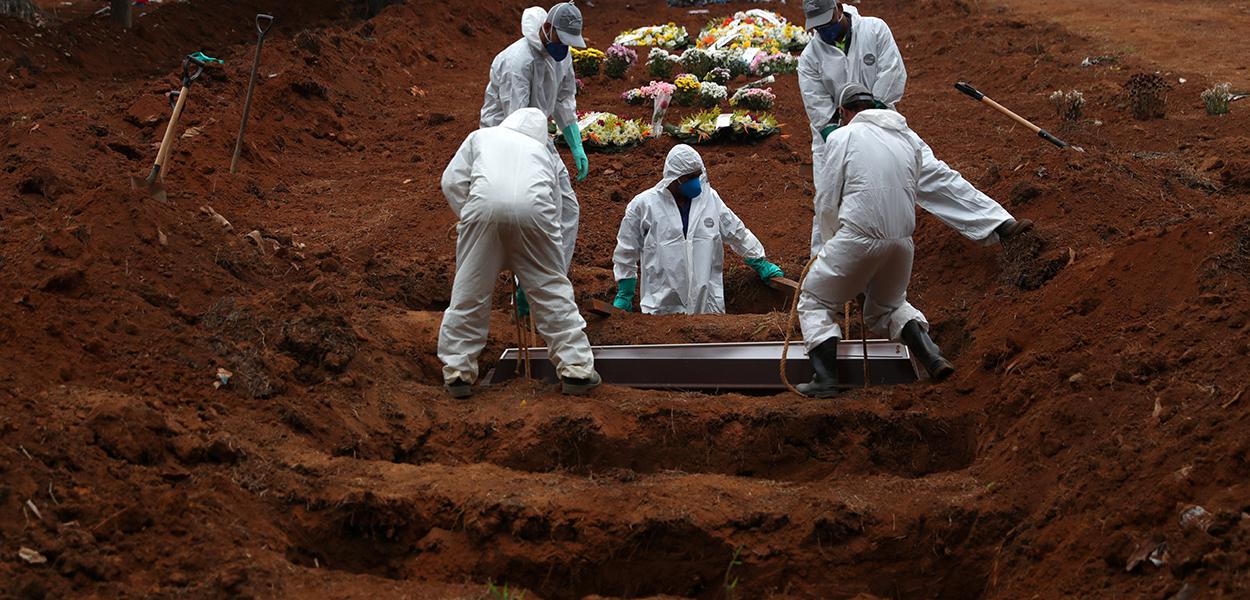 Coveiros com trajes de proteção enterram homem morto pela Covid-19 em cemintério em São Paulo 04/06/2020