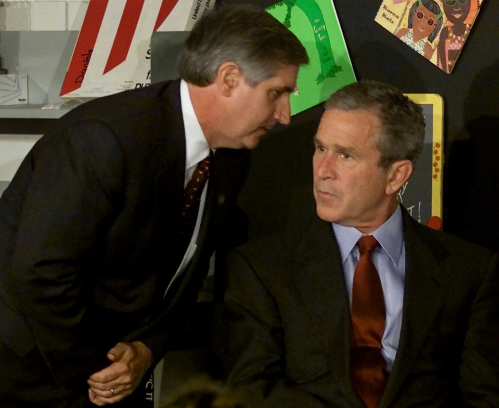 O então presidente dos EUA, George W. Bush, é informado do segundo avião a colidir com o World Trade Center por seu chefe de gabinete, Andrew Card, enquanto participa de uma leitura com crianças numa escola em Sarasota, na Flórida - Foto: Win McNamee/Reuters/Arquivo