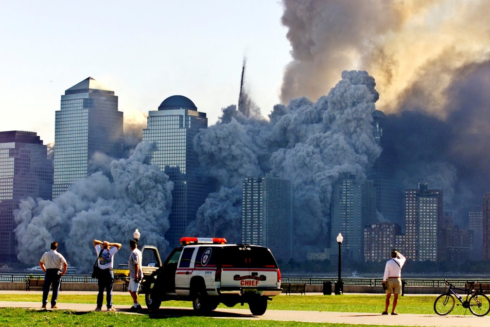 Pessoas observam de Nova Jersey enquanto a segunda torre do World Trade Center desmorona, cerca de 30 minutos após a primeira vir abaixo em Nova York, no dia 11 de setembro de 2001 - Foto: Ray Stubblebine/Reuters/Arquivo